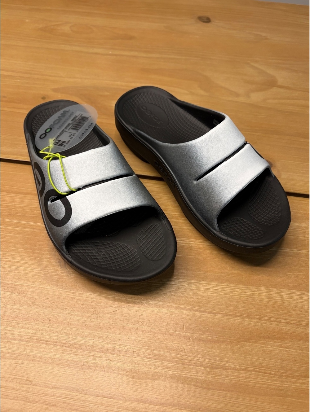 Oofos OOahh Slide Sandals in Silver and Black